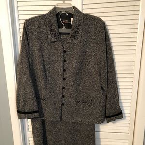 Grey tweed suit, skirt knee length. Very comfy